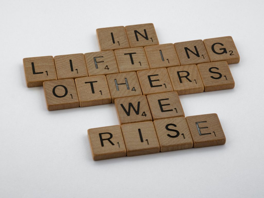 Quote, "In lifting others we rise."