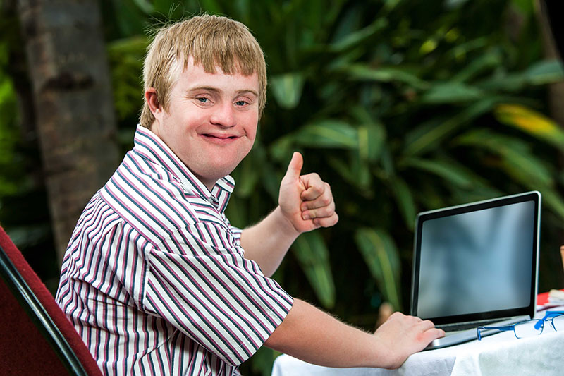 Student with a disability working on laptop.